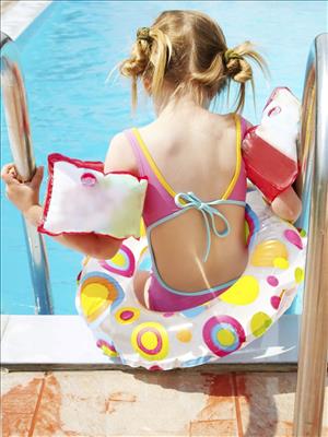 Premium Photo  Boy and girl wearing a swimsuit uses a foam pad to practice swimming  in a swimming pool