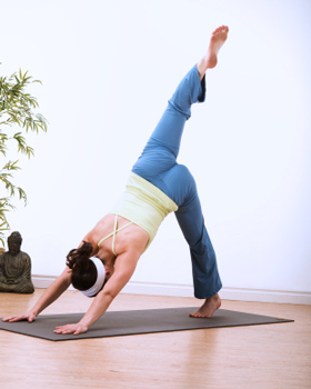 Slim woman doing upward facing dog exercise during yoga - a